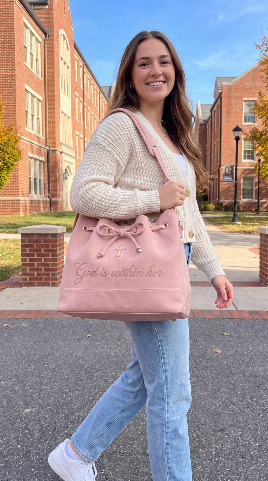 Walking across a brick college campus with the bag on her shoulder