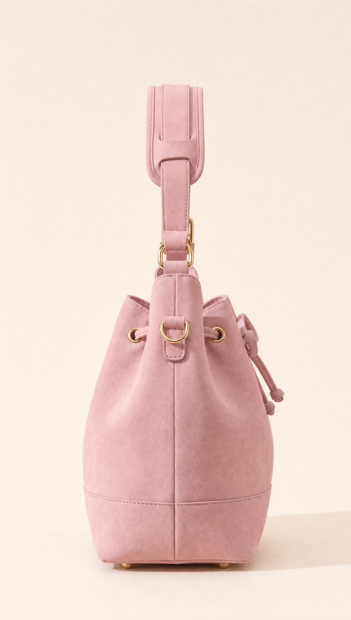 Side view of the pink 46:5 Bag with its padded shoulder strap and rose-gold hardware
